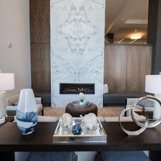 A beautifully designed modern living room featuring a stylish fireplace and elegant decor.
