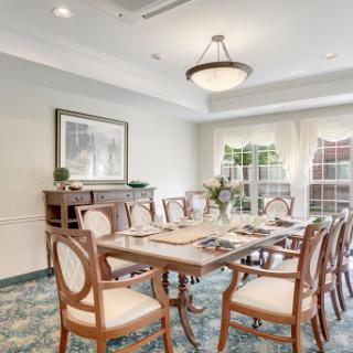 A well-appointed dining room featuring elegant furniture and soft natural light.