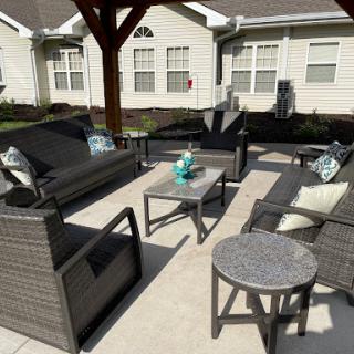 A cozy outdoor seating area featuring modern wicker furniture and a stylish coffee table.