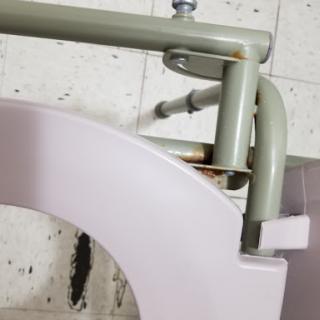Close-up view of plumbing components showing rust and wear.