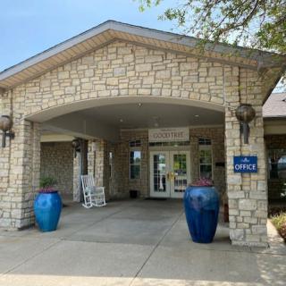 Entrance to a building with stone architecture and large blue pots.