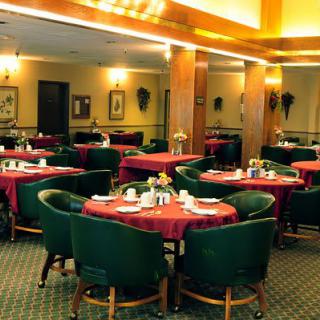 A cozy and elegant indoor restaurant dining area with neatly arranged tables and chairs.