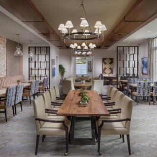 A stylish dining area with elegant chandeliers and contemporary furnishings.