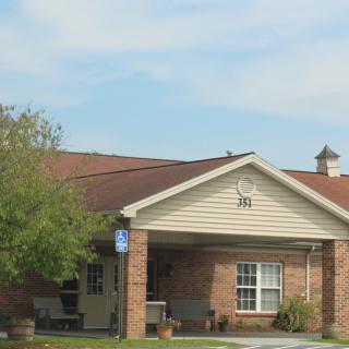 A suburban residential house with a brick exterior and a front porch.