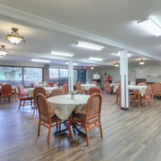 An indoor dining area with numerous tables and chairs arranged neatly.