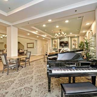 A luxurious lobby featuring a grand piano and elegant decor.