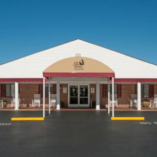 A symmetrical building entrance with a red and white awning.
