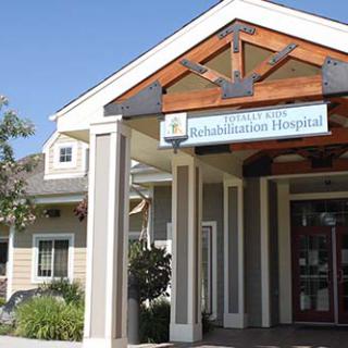 The entrance of a rehabilitation hospital, showcasing a welcoming design.