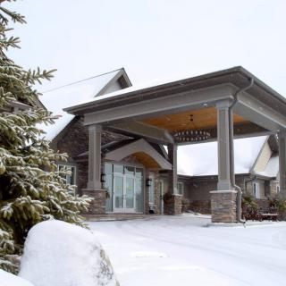 A house with a covered entryway blanketed in snow during winter.