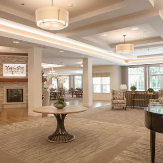 A spacious and modern living room with elegant lighting and comfortable furnishings.