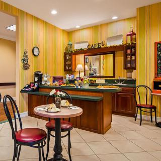 A cozy cafe interior with a breakfast setup and seating area.