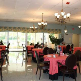 A spacious dining area featuring elegant chandeliers and vibrant table settings.