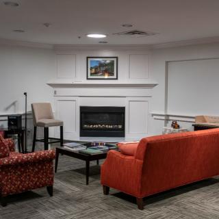 A cozy living room with a fireplace and comfortable seating.
