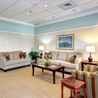 A cozy waiting room with comfortable seating and soft lighting.