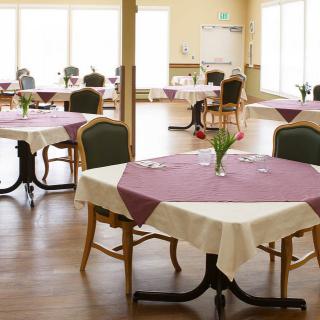 An empty dining room with tables set for service.