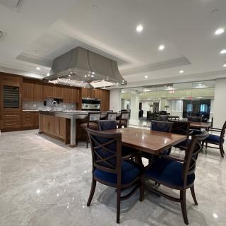 A luxurious open-concept kitchen and dining area featuring modern furniture and elegant lighting.