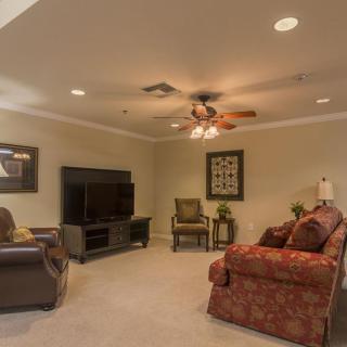 A cozy living room with comfortable seating and a large television.