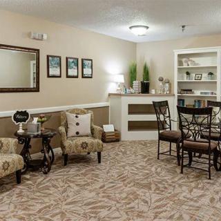 A cozy living room with comfortable seating, decorative elements, and a small dining area.