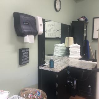 A tidy bathroom space featuring stacked towels and essential amenities.