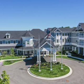 A large residential building with a roundabout entrance and well-maintained landscaping.