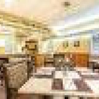 Spacious restaurant interior with neatly arranged tables and chairs.