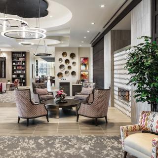 A modern lobby featuring elegant seating with stylish decor and bright lighting.