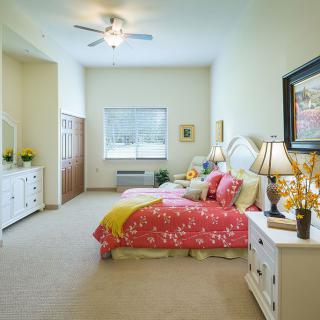 A bright and cozy bedroom with colorful bedding and elegant decor.