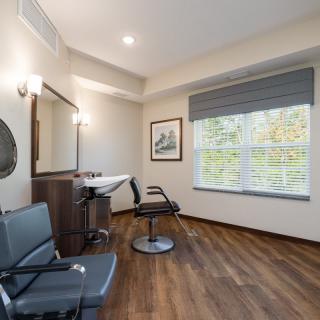 A modern salon interior with stylish furnishings and bright lighting.