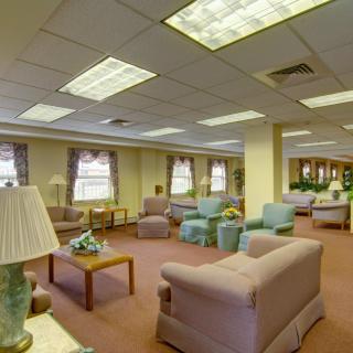 A spacious lounge with comfortable seating and soft lighting.