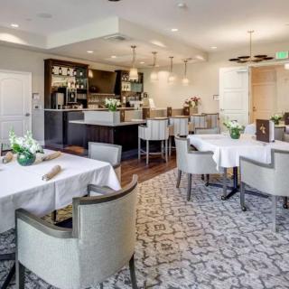 A stylish and elegantly designed restaurant dining area with neatly arranged tables and comfortable seating.