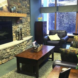 Cozy living room with a stone fireplace and comfortable seating.