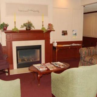 A cozy living room with a fireplace and comfortable seating.