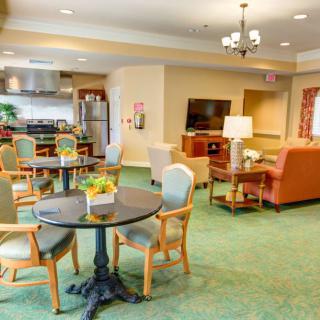A cozy living and dining area with a kitchen, featuring comfortable seating and modern furnishings.