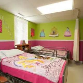 A colorful children's room featuring two beds with princess-themed bedding, decorated with bright green and pink walls and charming artwork.