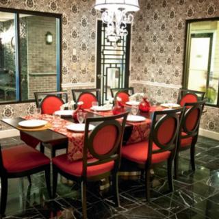Elegant dining room with red upholstered chairs and a beautifully set table.
