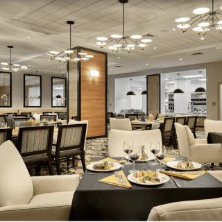 A modern and elegant restaurant dining room with stylish furnishings and ambient lighting.