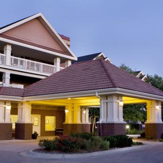 An elegant hotel entrance illuminated in the evening.