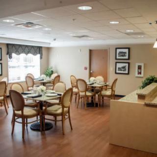 A cozy indoor dining area with elegantly set tables and comfortable seating.