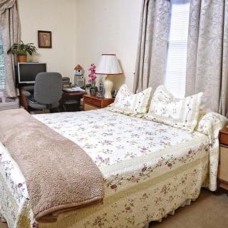 A cozy bedroom with a mixed-use home office space.