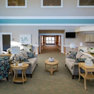 A welcoming and cozy seating area in a modern lobby, featuring comfortable furniture and a warm atmosphere.