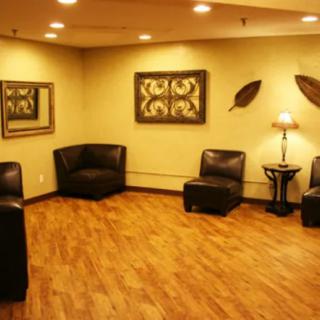 A modern waiting room with cozy seating and stylish decor.