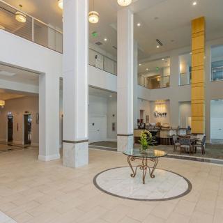 A modern lobby with tall columns, elegant decor, and a reception area.