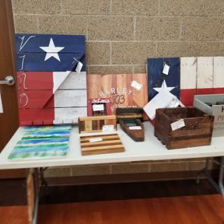 Handcrafted wooden items featuring the Texas flag, displayed at a craft fair.