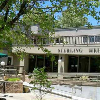 Exterior view of the Sterling Heights building surrounded by trees.