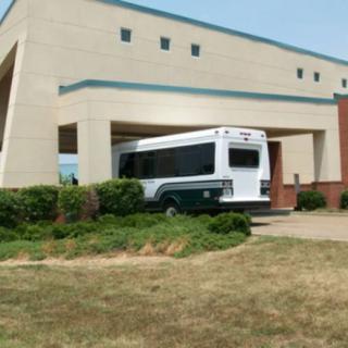 A bus has accidentally driven into the side of a building.