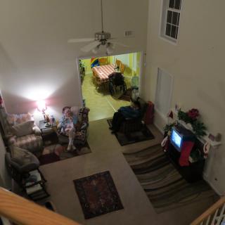 A cozy living room with people relaxing and watching TV.