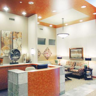 A modern reception area with stylish furniture and artwork on the walls.