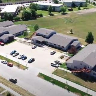 Aerial view of a residential area with buildings and parking lot.