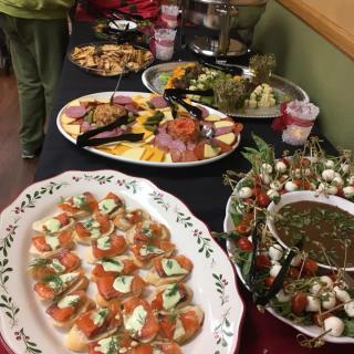 A variety of appetizers are displayed on a buffet table, ready for guests to enjoy.