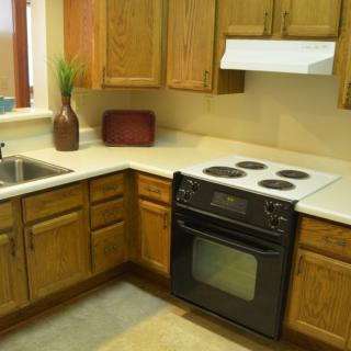 A cozy kitchen with wooden cabinets and a modern stove.